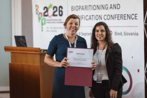 Dr. Anna Sandak holding a ceritficate